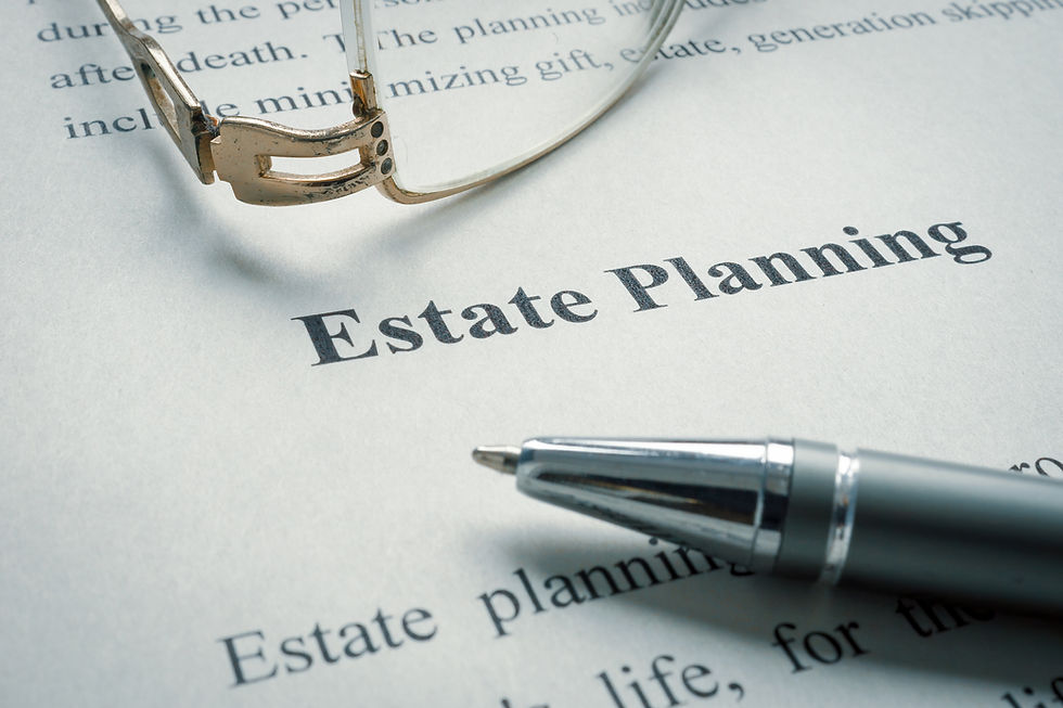 Closeup of a form labeled Estate Planning laying on a table with a pen and a pair of reading glasses.