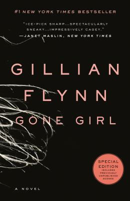 Black book cover with white tangled lines and pink text: "Gillian Flynn Gone Girl." Features a round orange label for special edition.